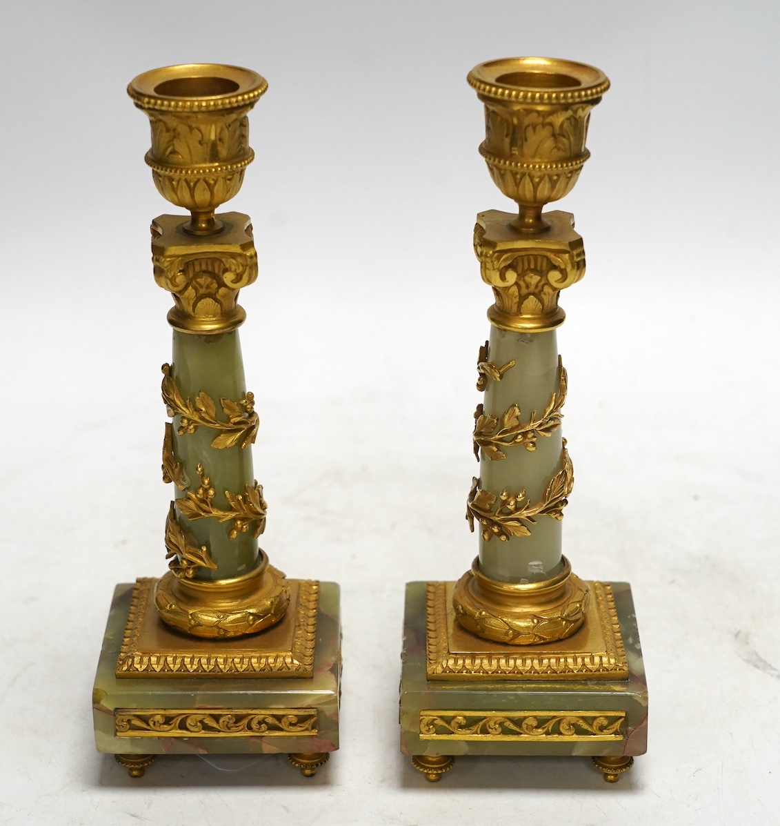 A pair of early 20th century French ormolu mounted onyx candlesticks, 20cm high